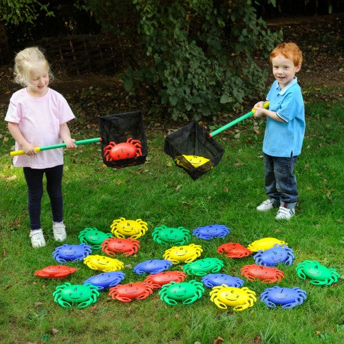 Set of colorful crab-shaped lawn toys in bright red, blue, green, and yellow