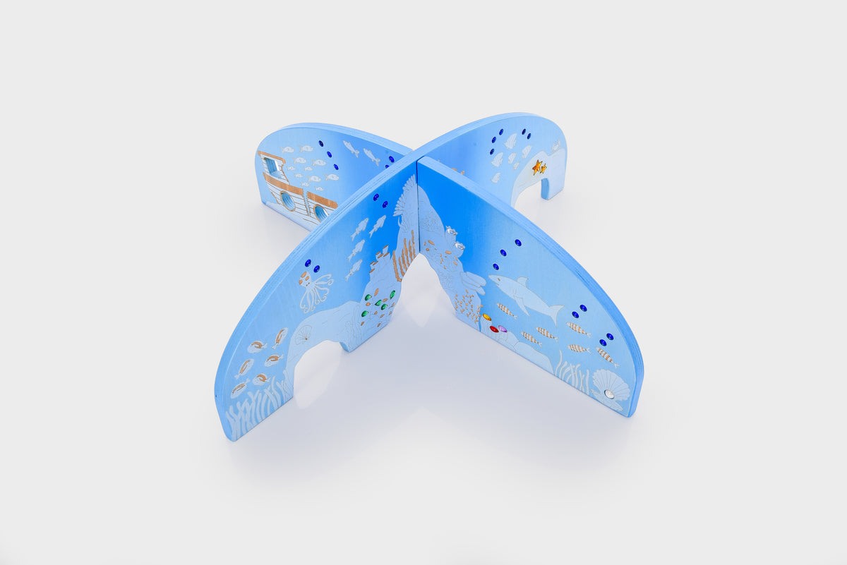 Blue ocean-themed play divider with arched panels and cutout wave pattern
