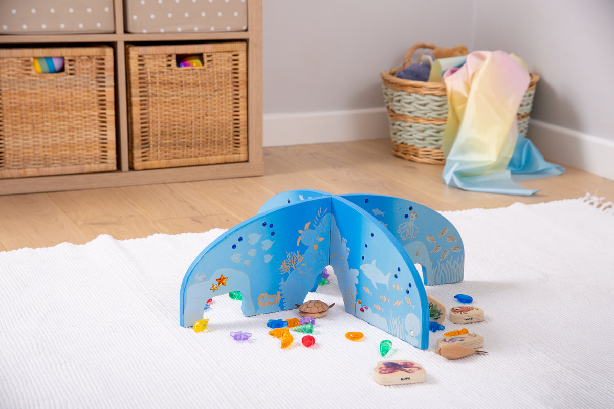 Blue arched ocean play divider with cutout wave design