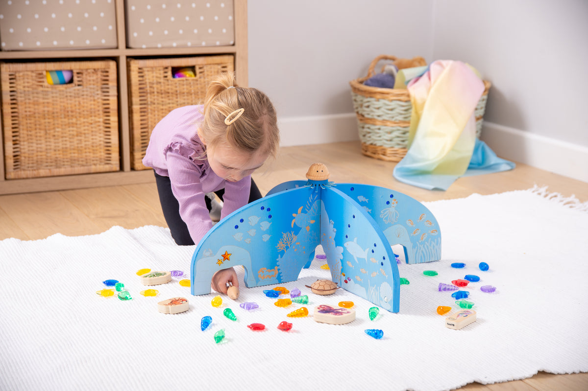 Blue ocean-themed arched divider with cutout sea graphic details