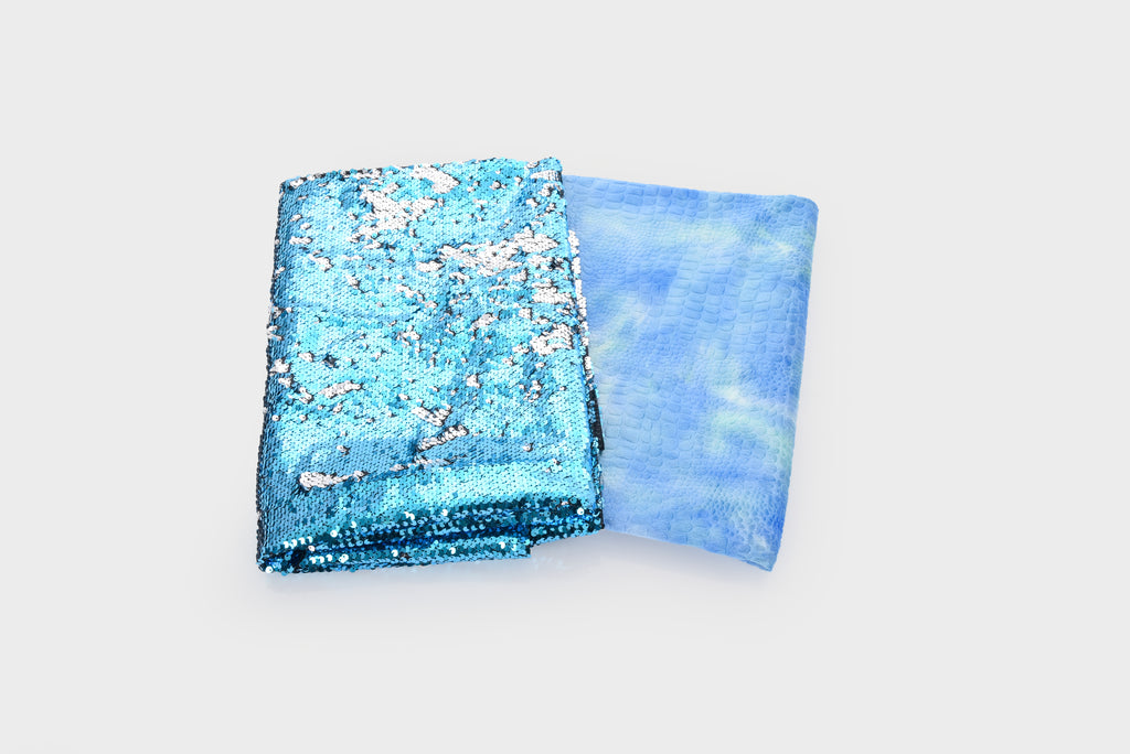 Two folded blue textiles: left glitter sequin fabric and right sheer gauze