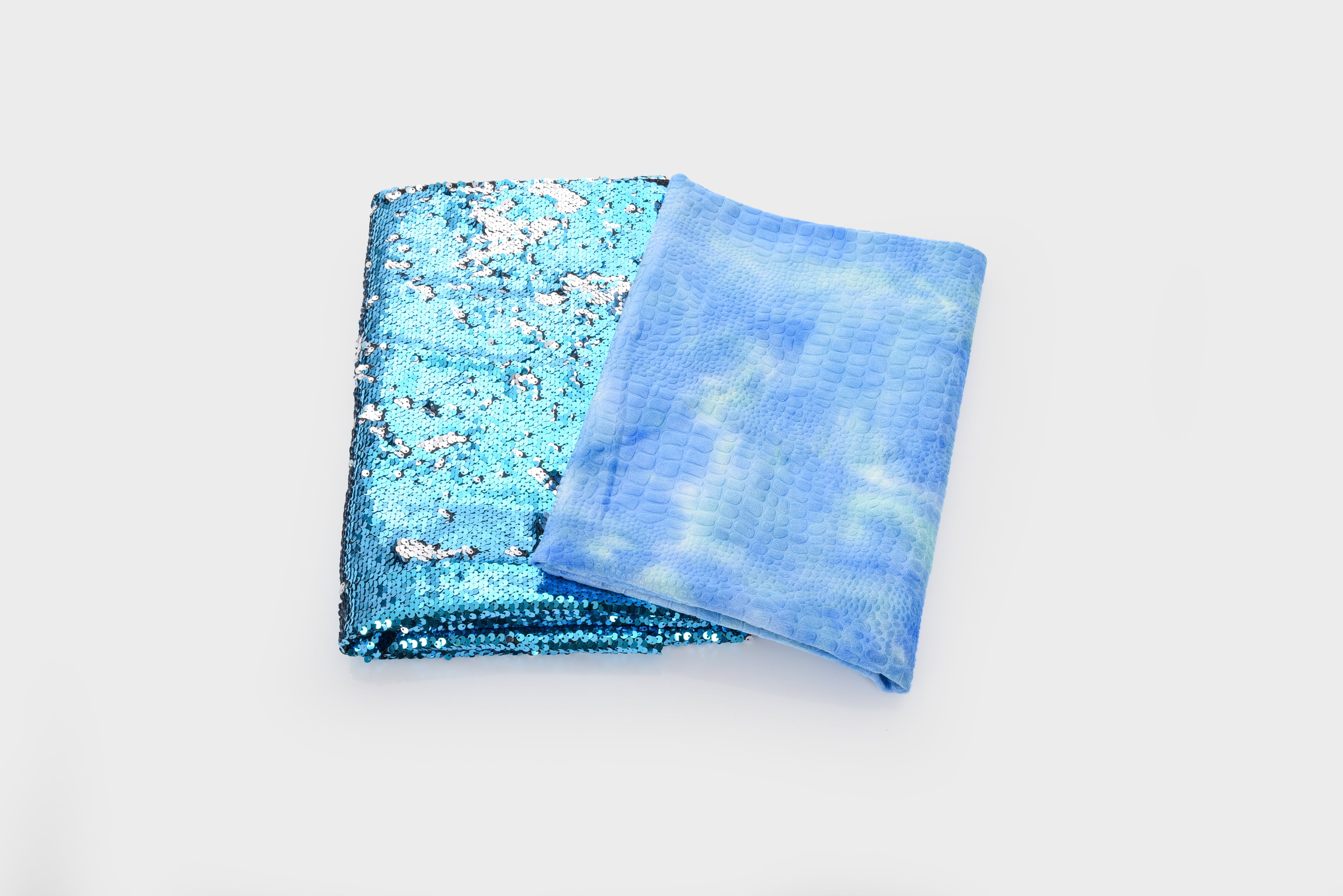 Set of 2 folded blue fabrics: glitter sequin panel and sheer gauze scarf
