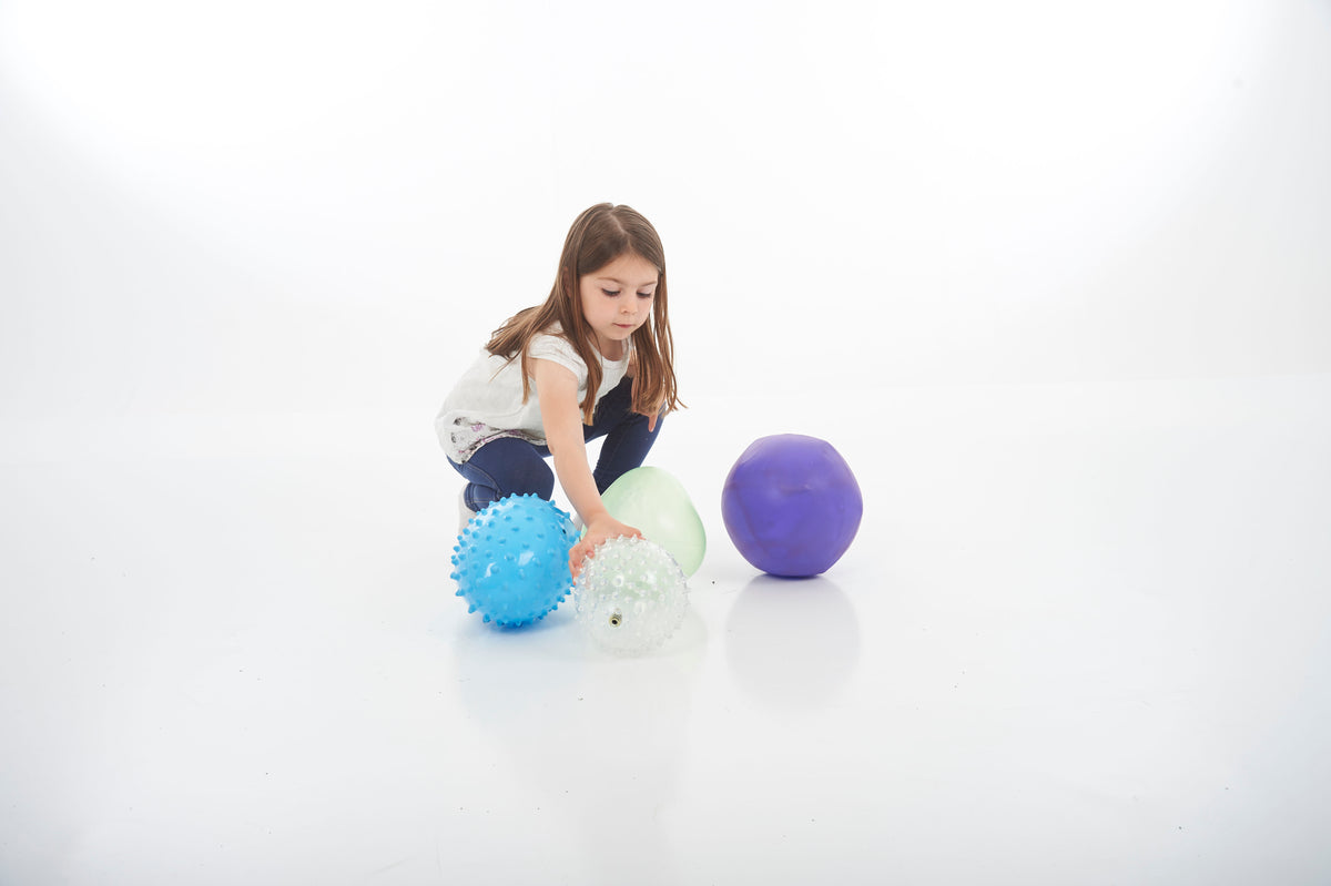 Sensory ball set with blue spiky and white speckled balls plus green and purple smooth balls