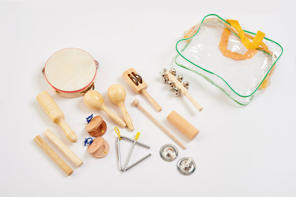 Wooden percussion set pieces with drum, hand clappers, bells, and ribbon bag