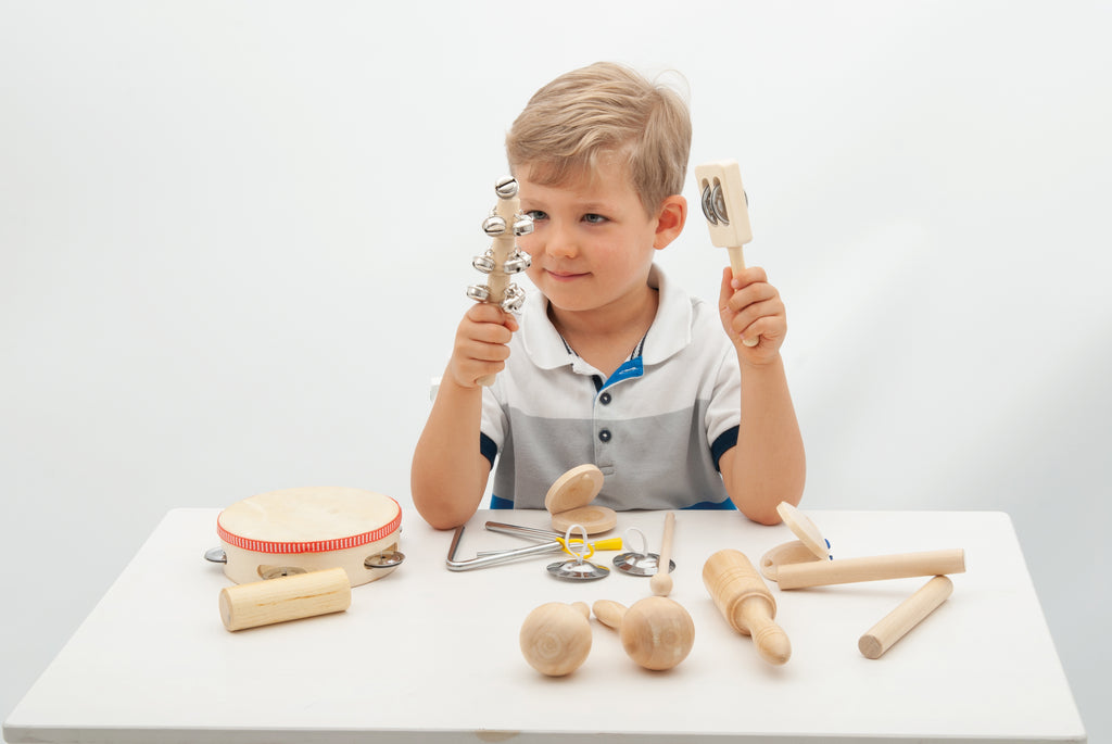 Wooden percussion set with drum, bells, and shakers held by child