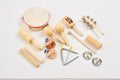 Wooden percussion set with round drum, shakers, xylophone bar, and cymbals