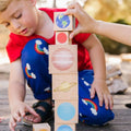 Wooden stacking blocks with planet and space-themed circle illustrations
