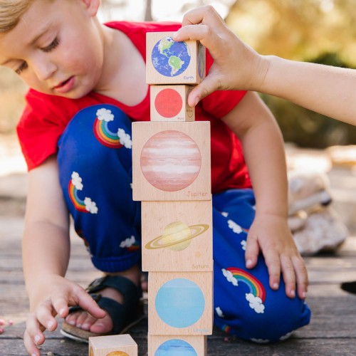 Wooden stacking blocks with planet and space-themed circle illustrations