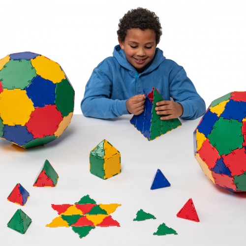 Colorful polyhedron construction pieces with child in blue hoodie, assorted shapes
