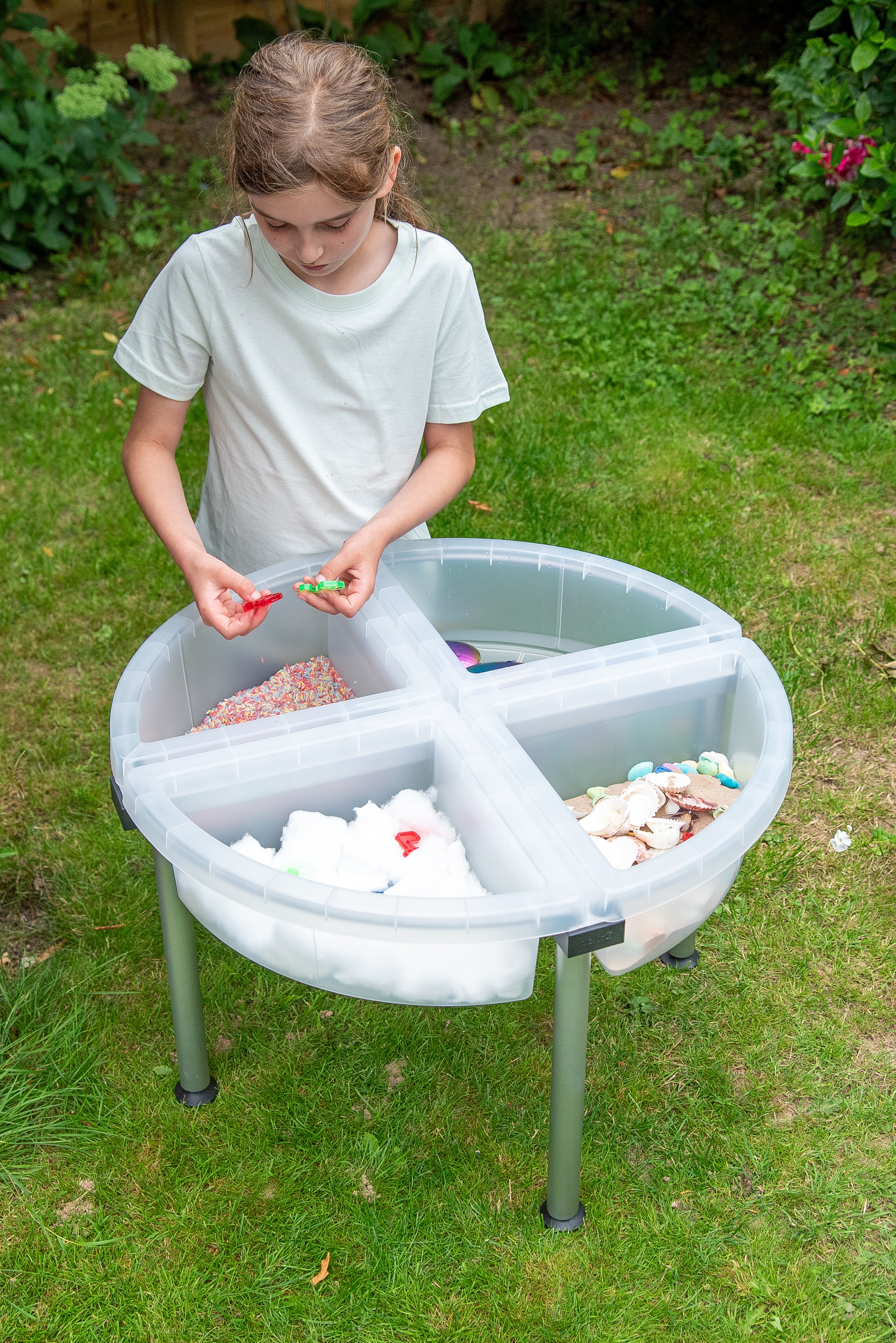 Clear quadrant tray on metal stand with craft pieces in compartments