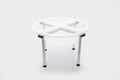 Four-compartment clear plastic tray on metal stand