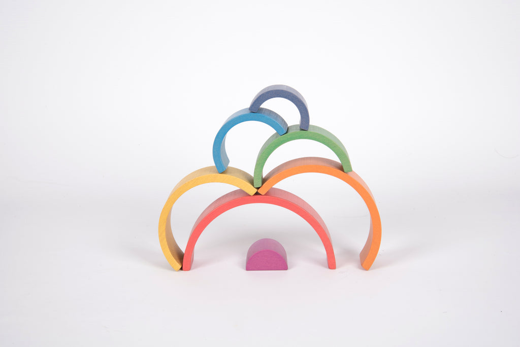 Stacked rainbow arch toy rings with curved multicolor arches and a small purple base