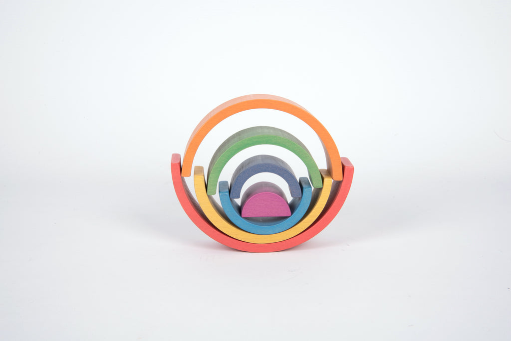 Round stacked rainbow arch toy with interlocking multicolor arcs and a purple center block