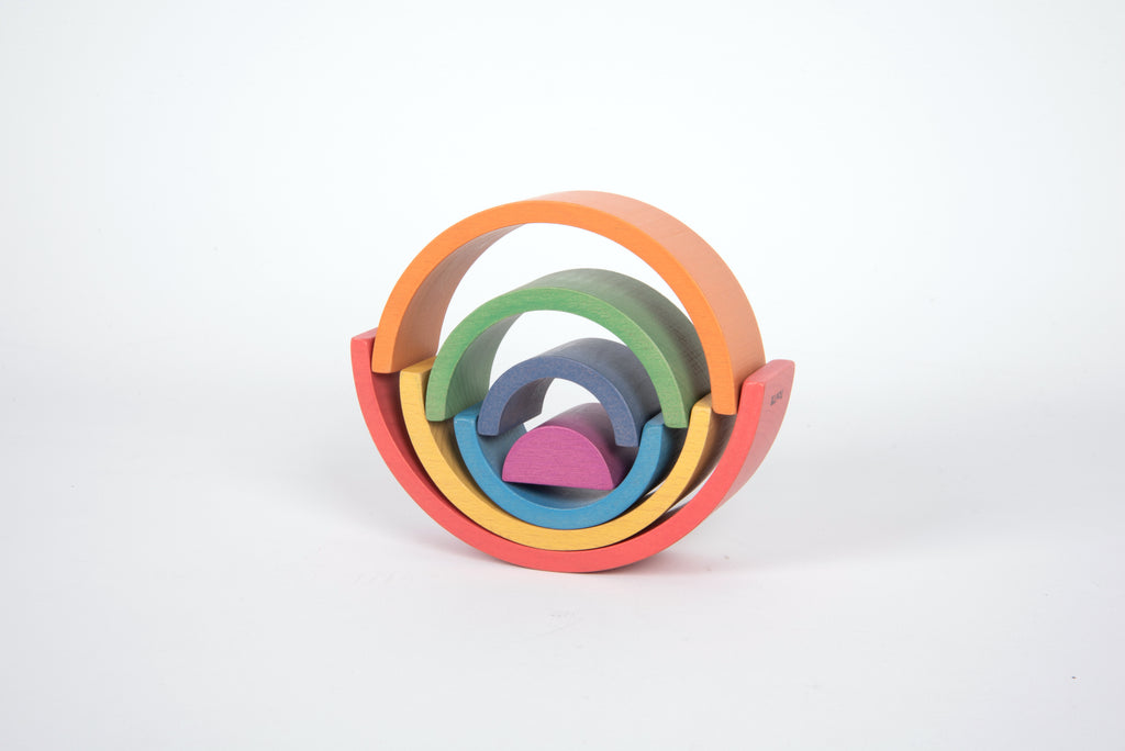 Circular rainbow arch toy with nested curved arcs in red, orange, yellow, green, blue, and purple