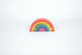 Single rainbow arch toy with layered arcs in red, orange, yellow, green, blue, and purple
