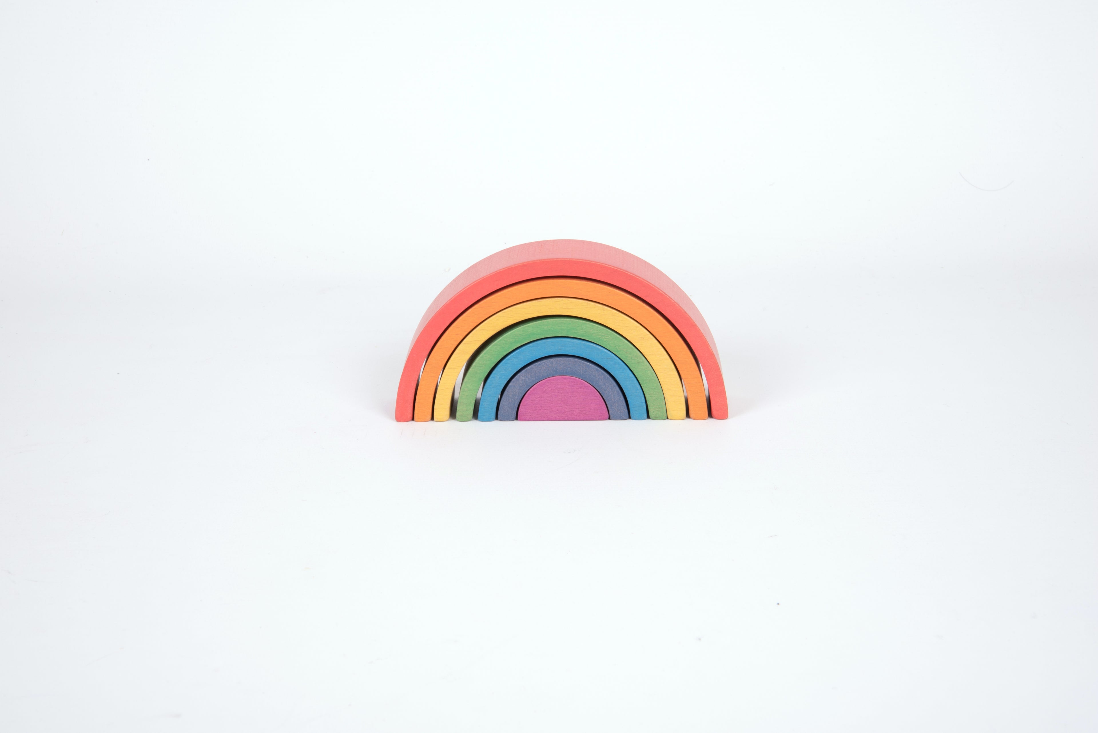 Single rainbow arch toy with layered arcs in red, orange, yellow, green, blue, and purple
