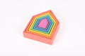 Single rainbow nested house block with concentric colored frames on pink base