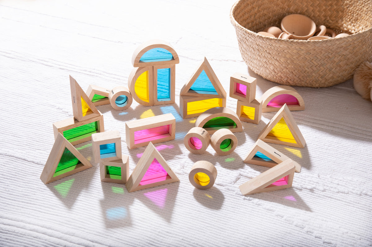 Wooden rainbow block set with multicolored geometric inlay pieces and rings
