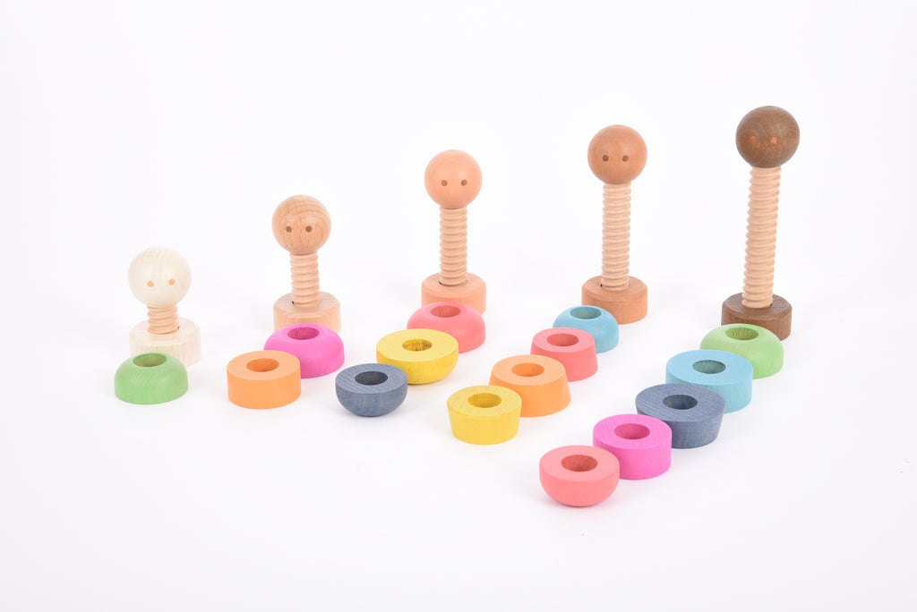 Rainbow wooden peg people and multicolor stacking rings arranged in rows