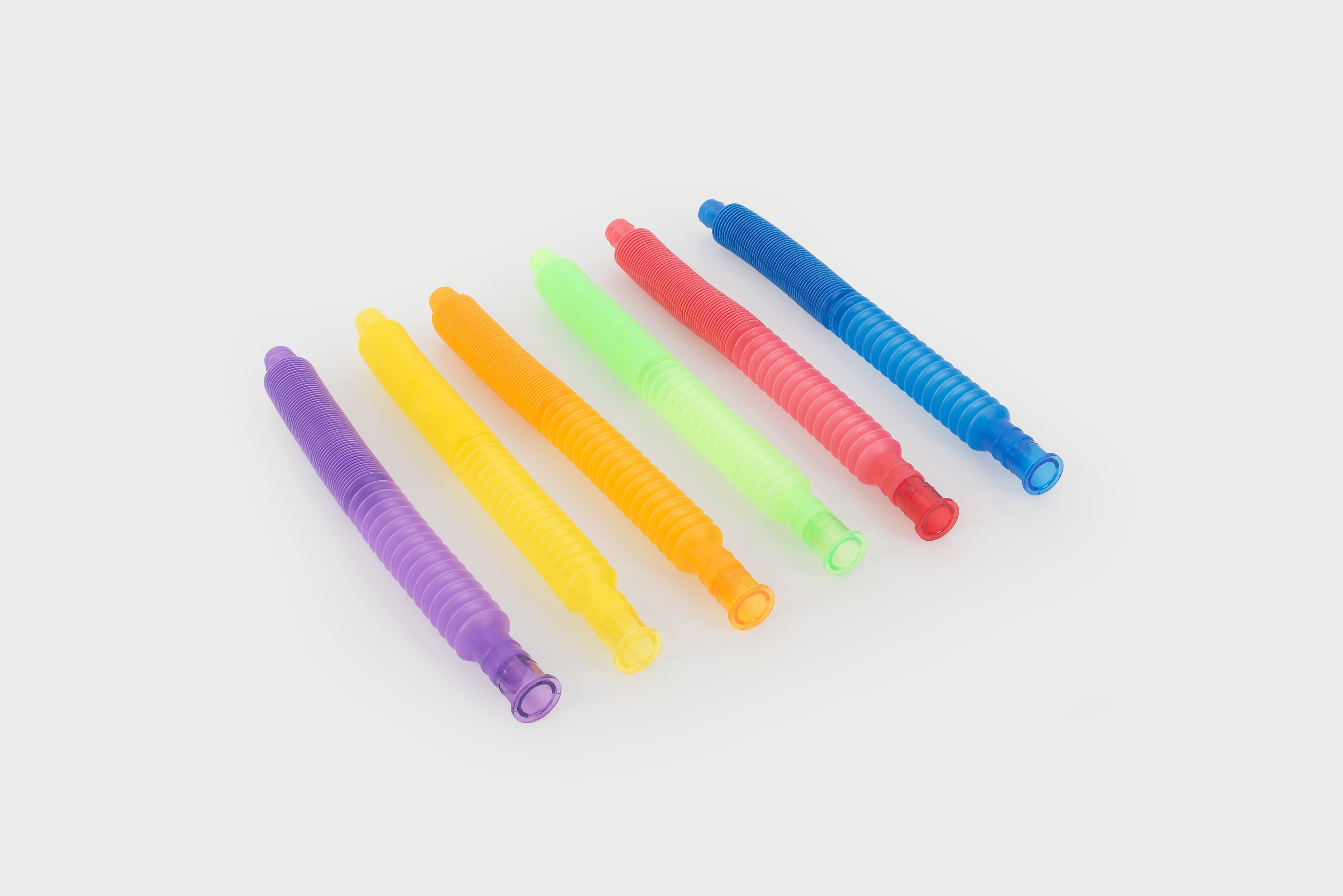 Set of rainbow flexible plastic tubes in assorted colors, ribbed with open ends