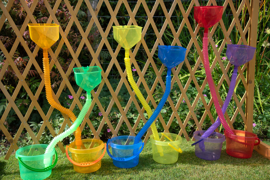 Close-up of colorful flexible tube sprayers with attached scoop cups on a lattice frame
