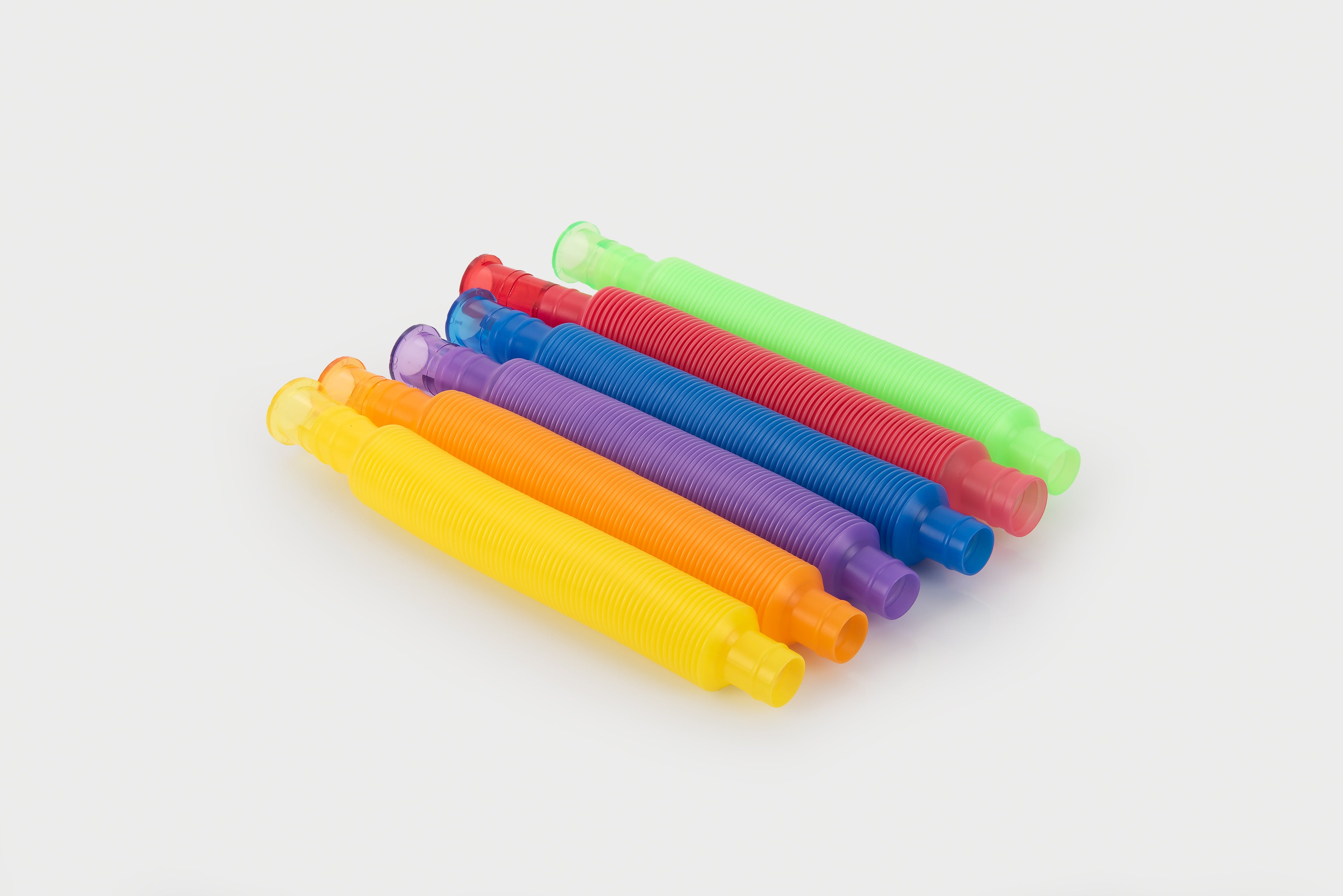 Assorted rainbow flexible tubes with ribbed design and curved open ends
