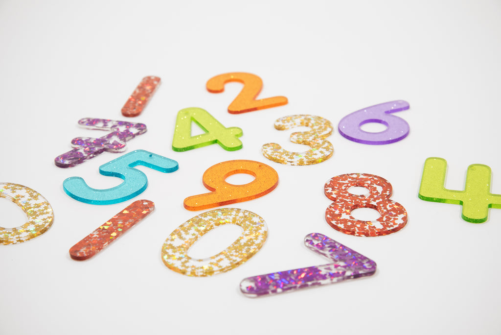 Rainbow glitter number set with scattered digits 1–8 in bright rainbow colors