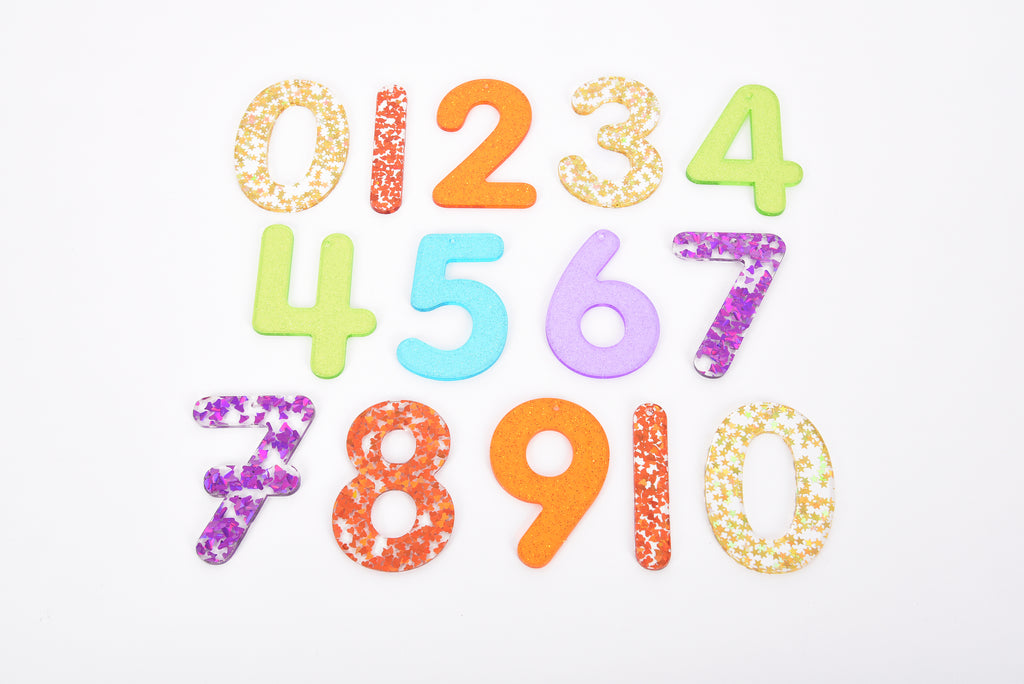 Rainbow glitter number set featuring digits 0–10 in orange, blue, purple, and gold