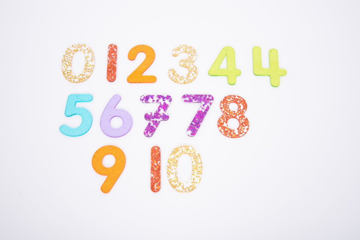 Rainbow glitter number set featuring digits 0–10 in multicolor with glittery finishes