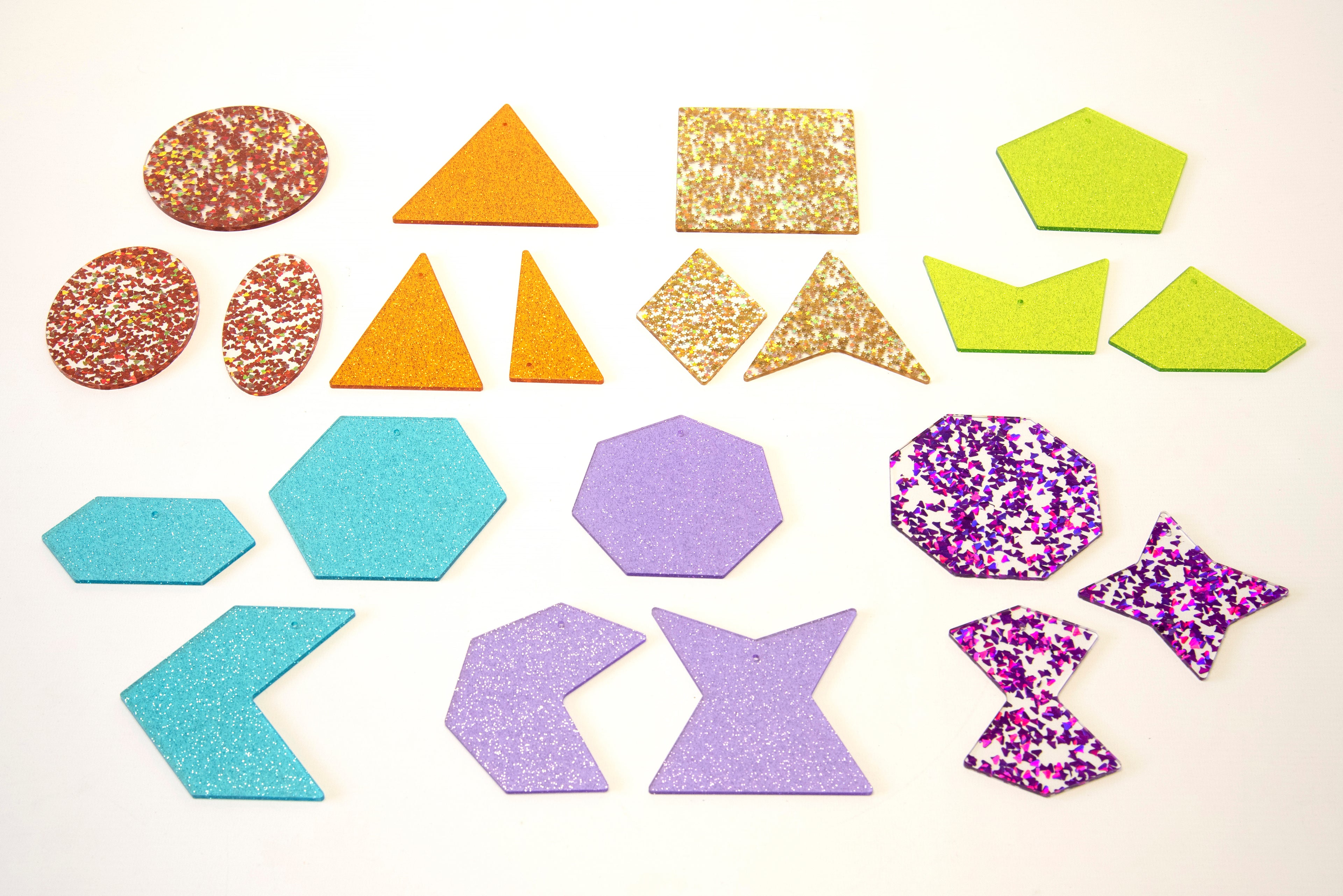Assorted rainbow glitter shapes in multiple sizes: circles, triangles, squares, stars