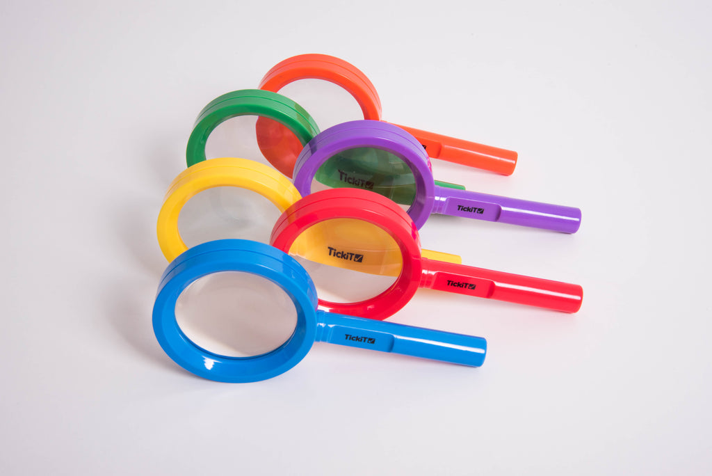 Set of colorful handheld magnifying glasses with circular lenses and colored handles