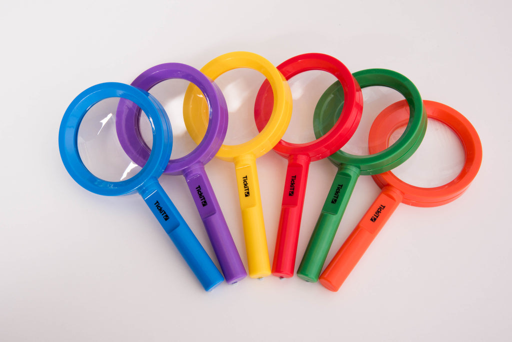 Overlapping rainbow magnifying glasses with circular lenses and colored plastic handles