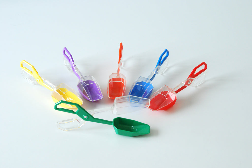 Cluster of colorful plastic tongs with scoop ends in bright colors