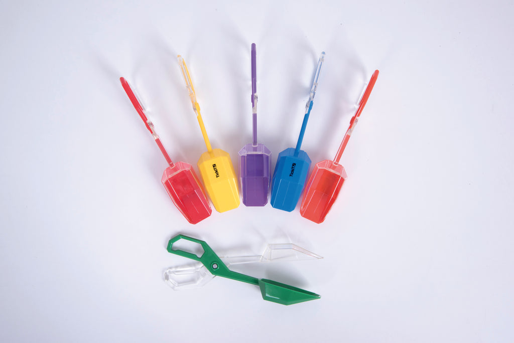 Multi-color plastic tongs with scoop ends on white background, green and red