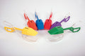 Assorted colorful plastic tongs with scoop ends, flat pack layout