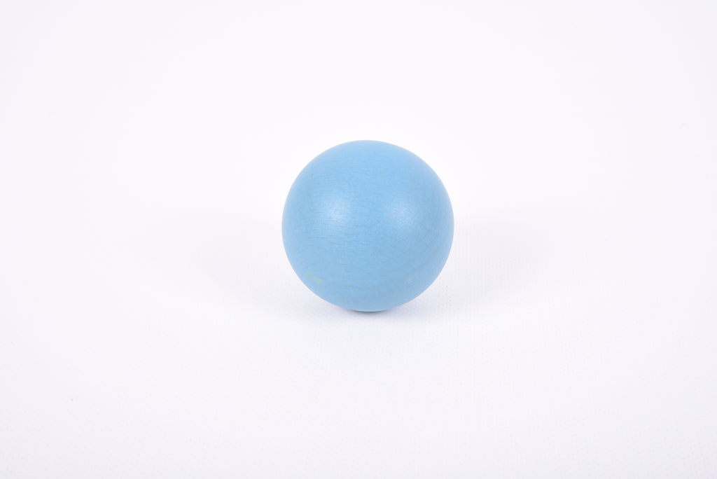 Single light blue wooden ball with smooth round surface