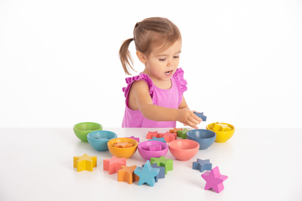 Colorful bowls with star-shaped accessories for pretend play