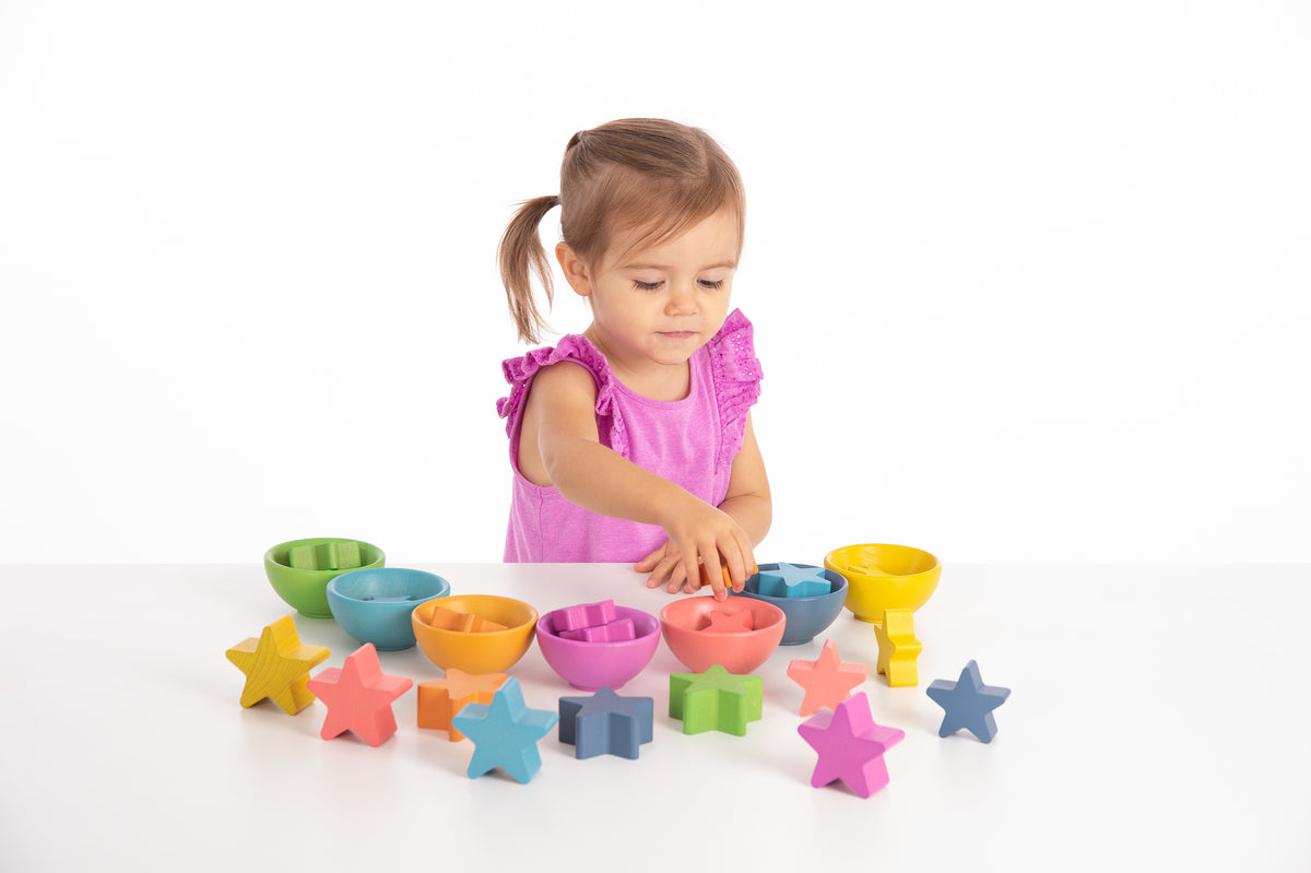 Set of colorful child bowls with star-shaped pieces for pretend play