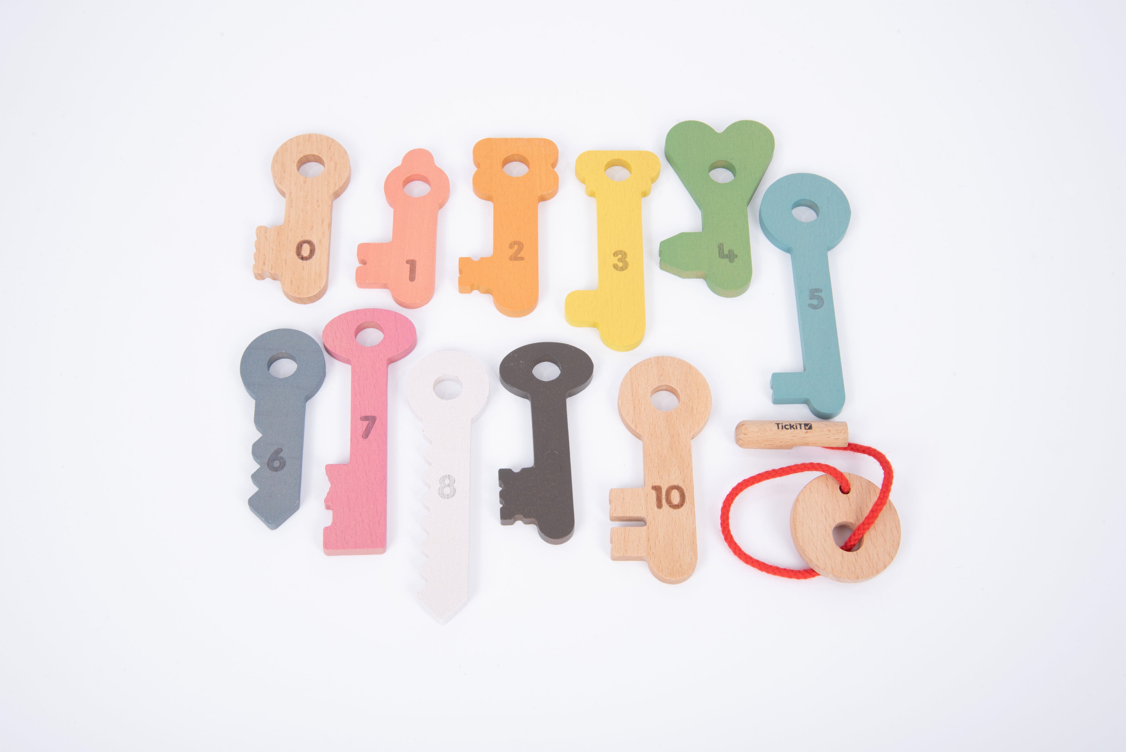 Flat lay of colorful wooden counting keys with numbers 1–10 and red string key holder.