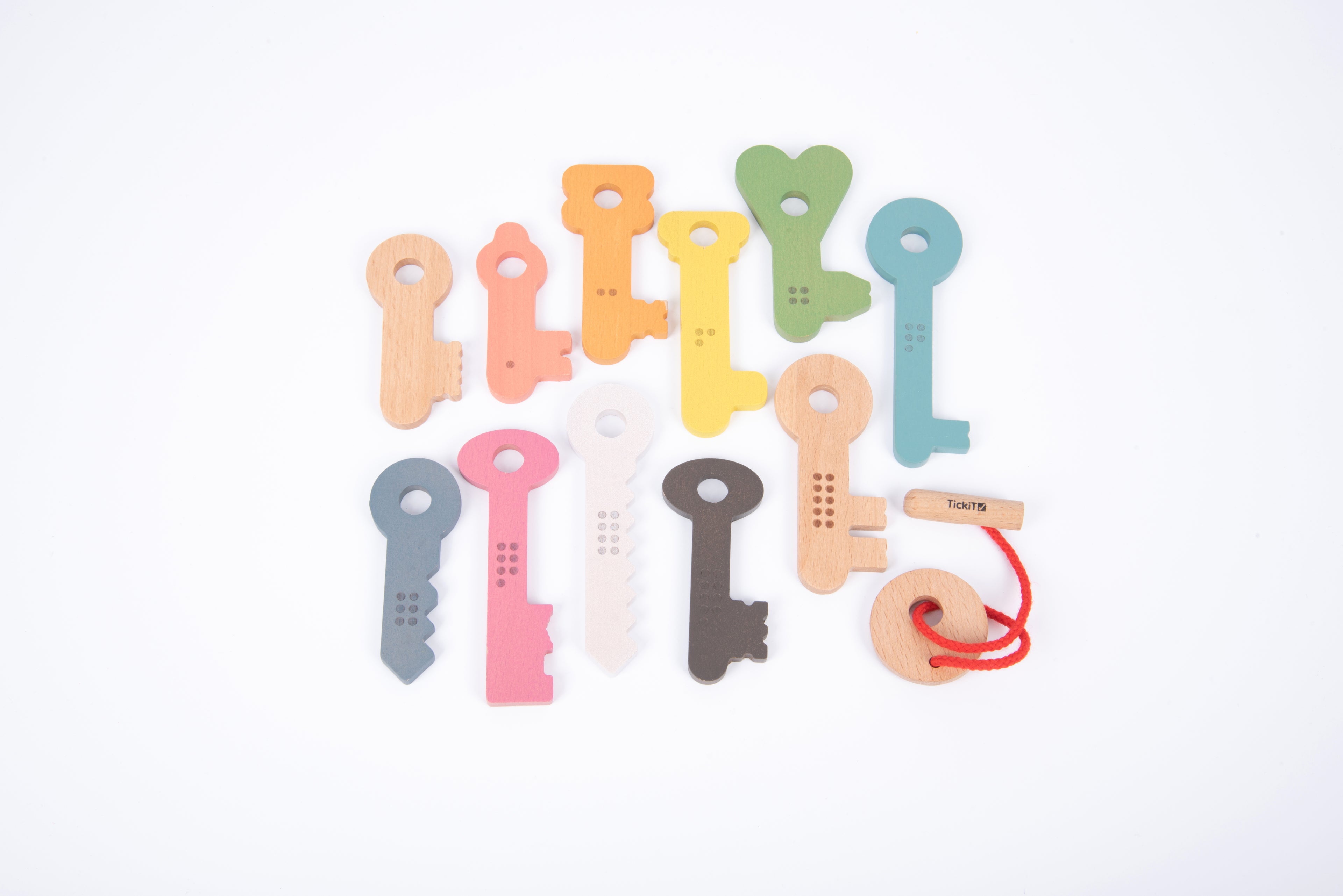 Colorful wooden key pieces with printed numbers 1–10 and a red string key holder.