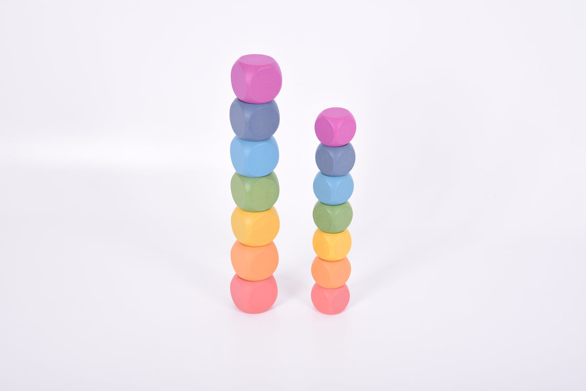 Rainbow wooden cubes arranged in two vertical stacks, multicolored small blocks