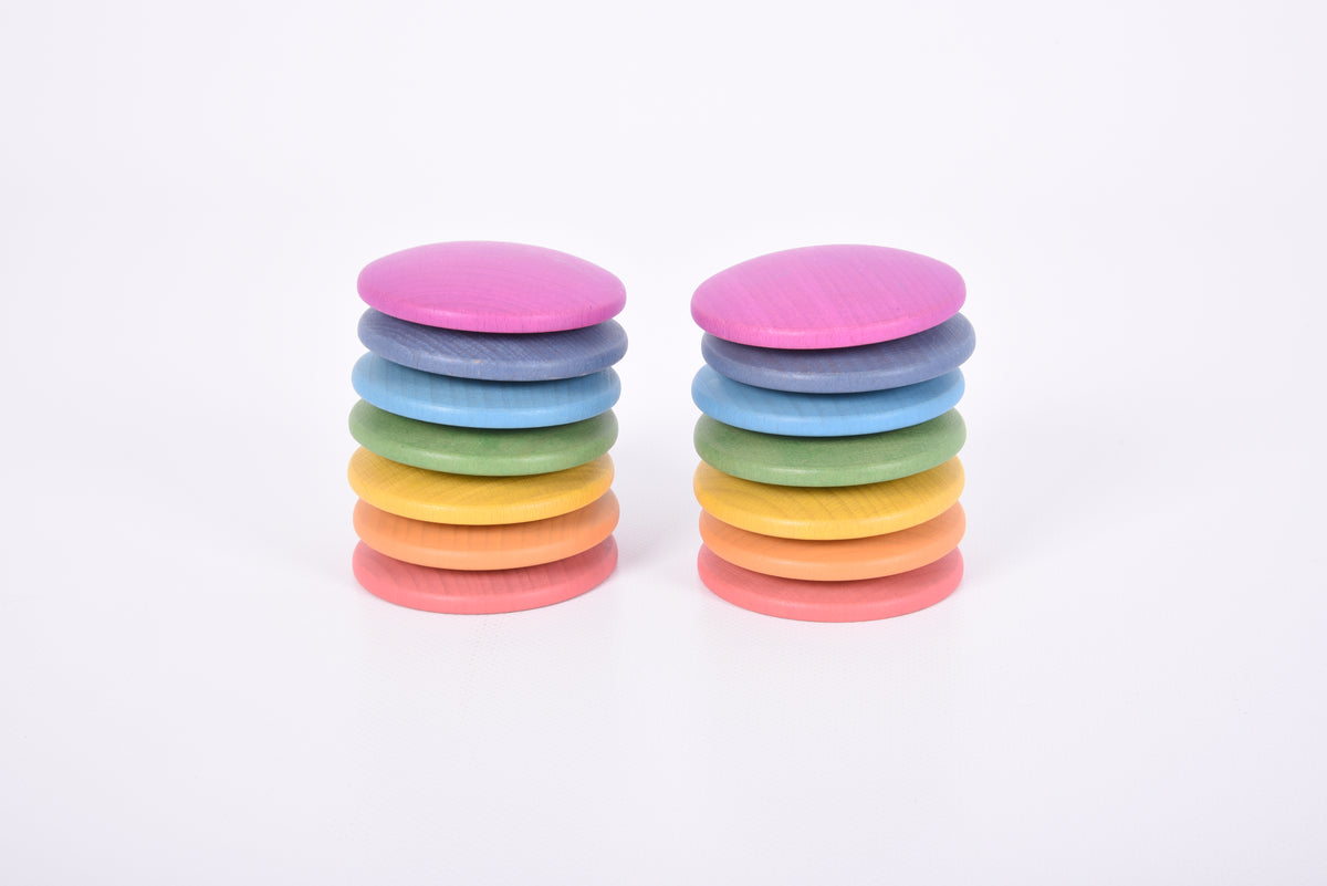 Two stacked towers of round wooden discs in pink, blue, green, and yellow
