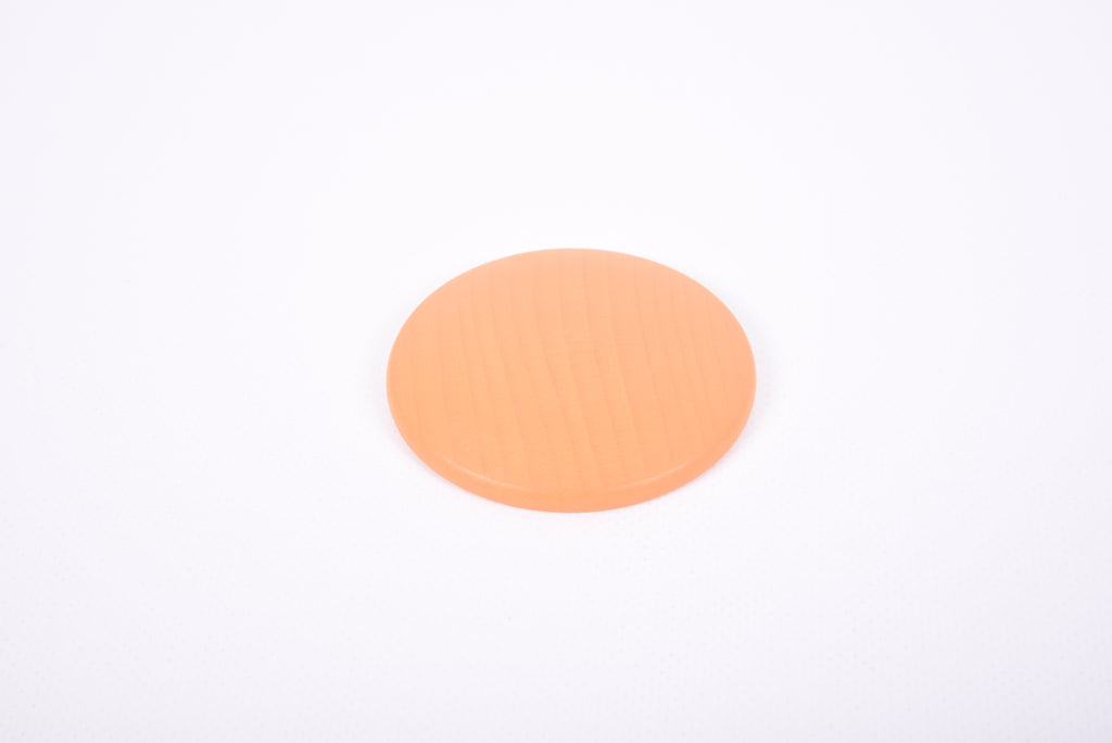 Single round orange wooden disc with smooth ridged surface