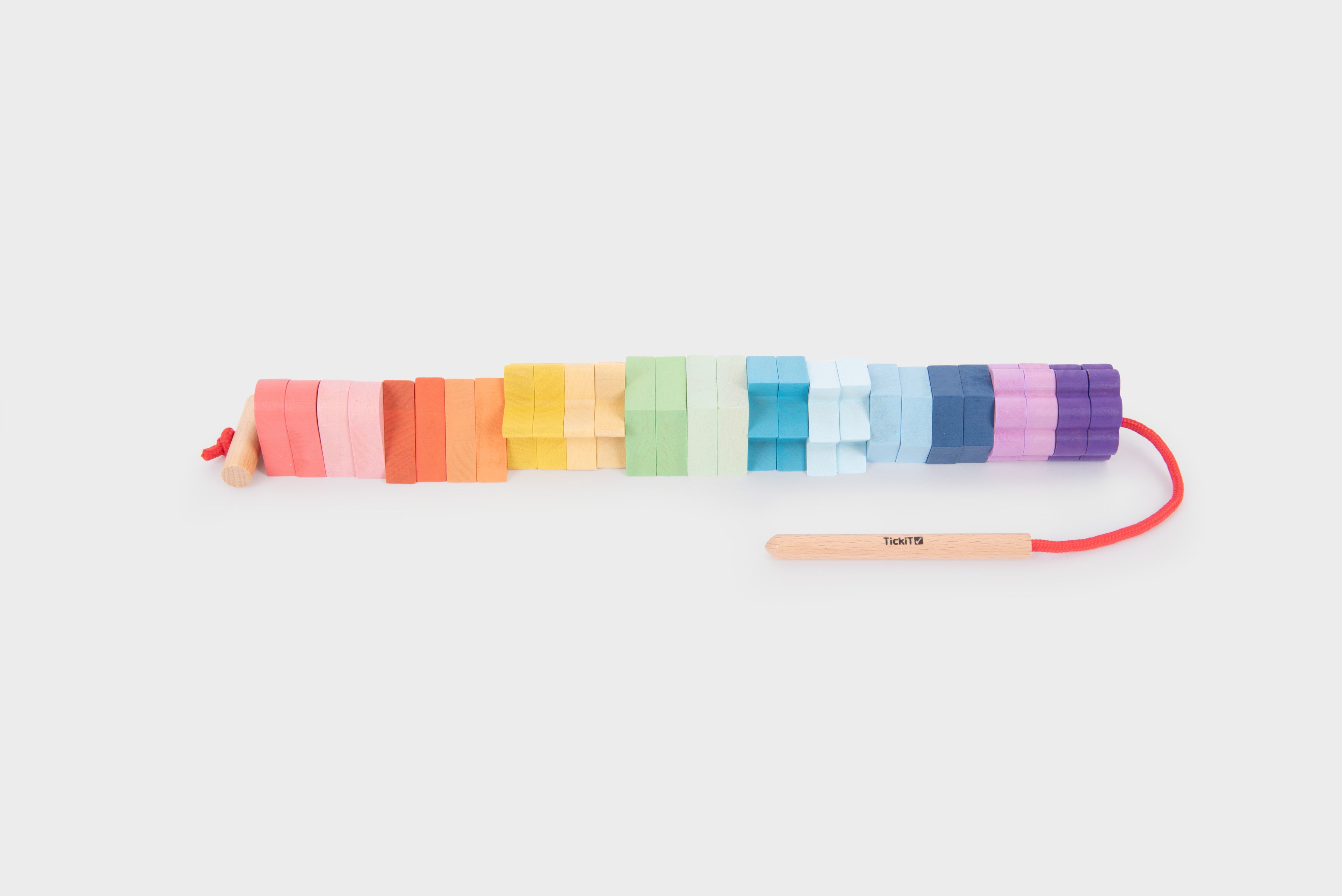Rainbow wooden lacing shapes with colorful interlocking blocks on a red cord