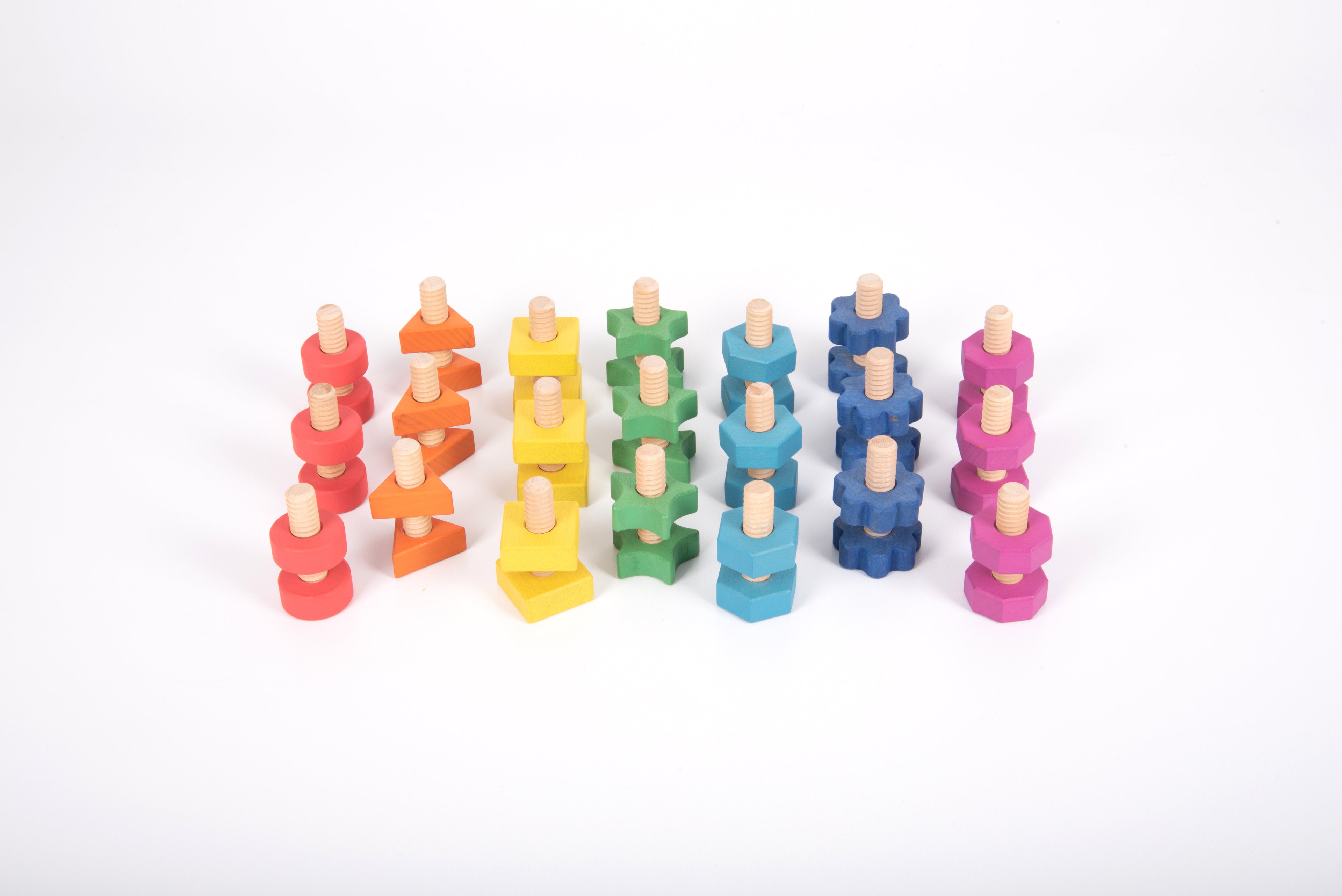 Rainbow wooden nut-and-bolt building pieces arranged in several towers, multicolor