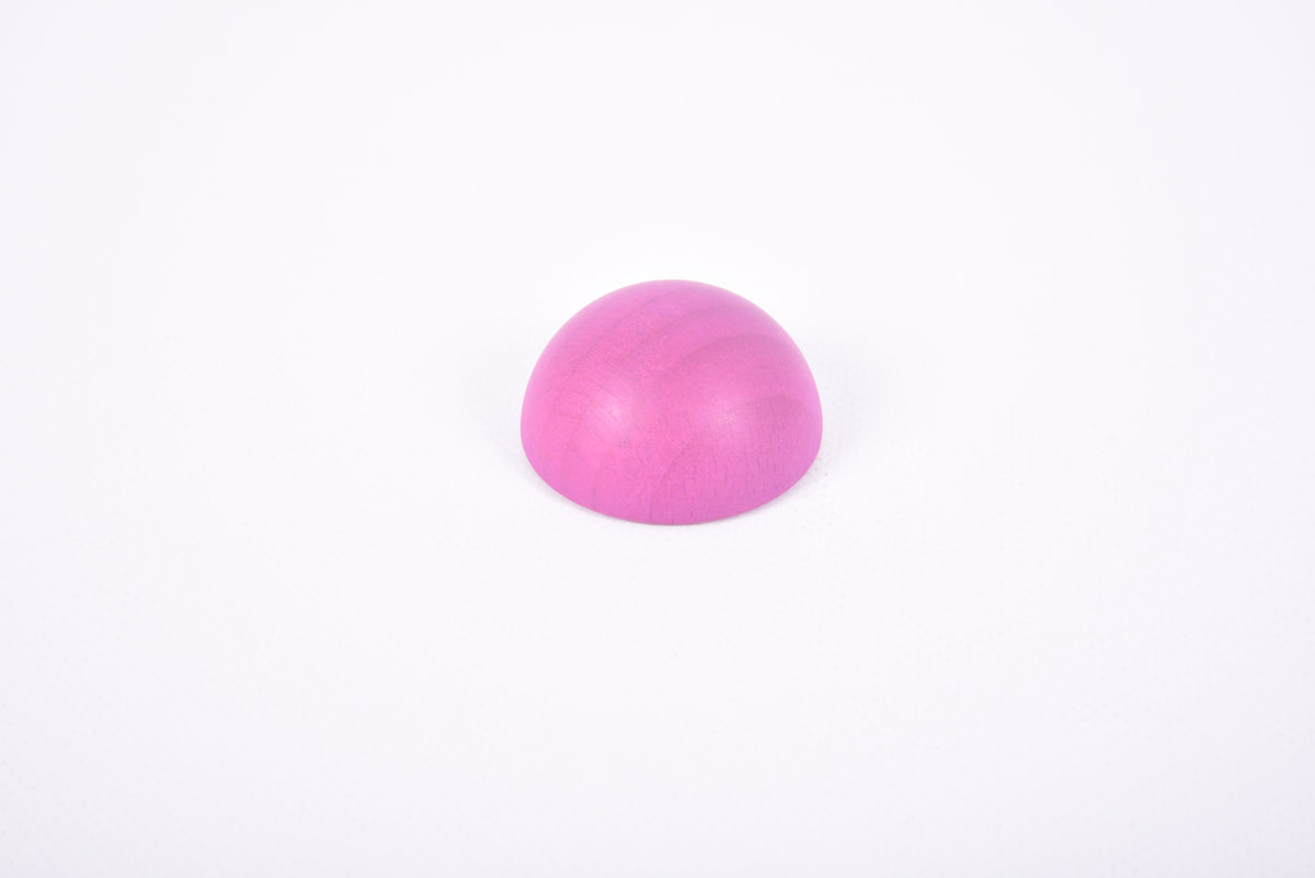 Single pink wooden hemisphere toy
