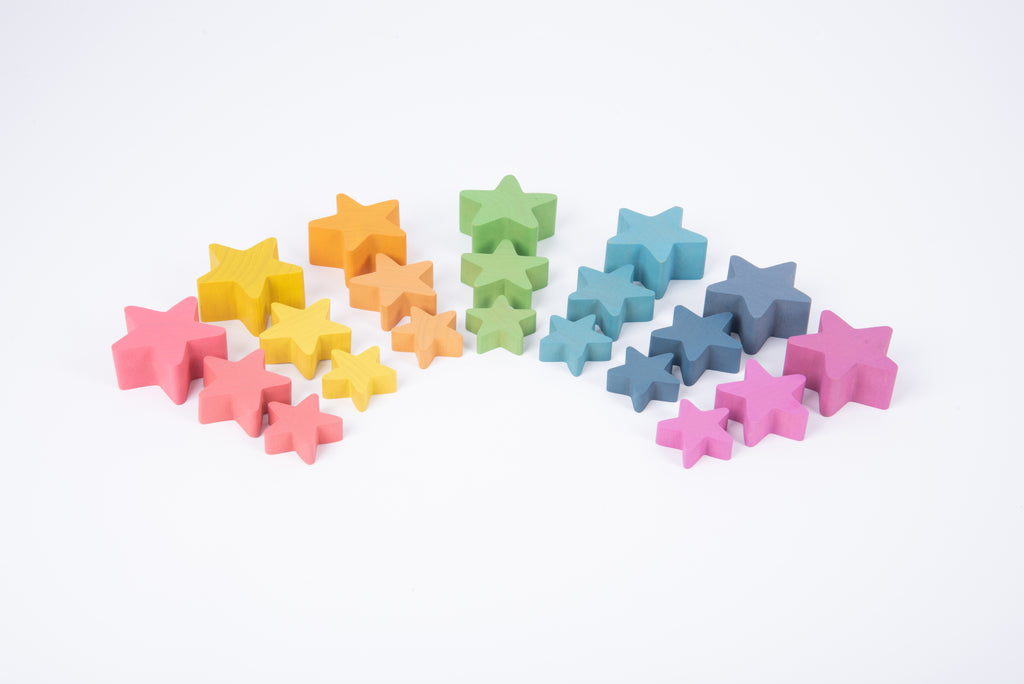 Multicolor wooden star blocks, assorted rainbow colors in a pile