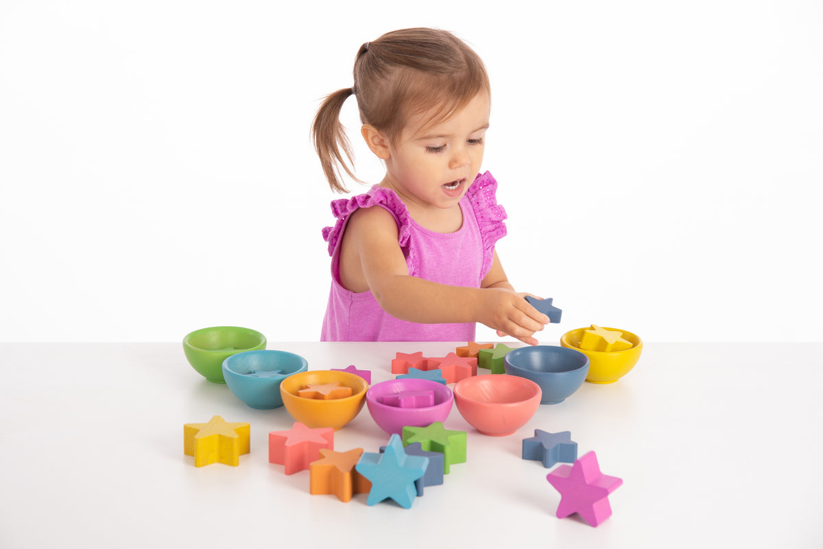 Assorted multicolor wooden star blocks with bowls for sorting