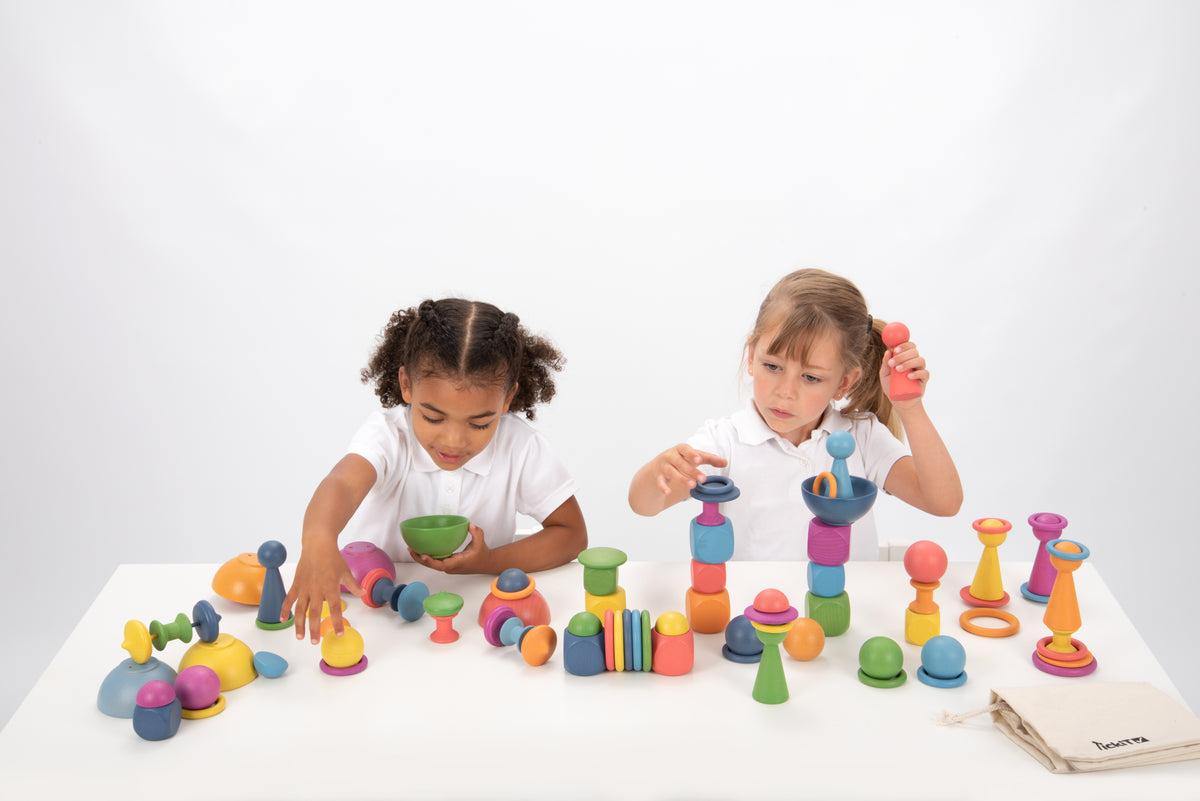 Wooden rainbow stacking toy set with colorful pegs, rings, and wooden balls on table