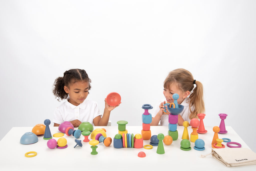 Wooden rainbow stacking toy set with colorful pegs, rings and balls arranged for play